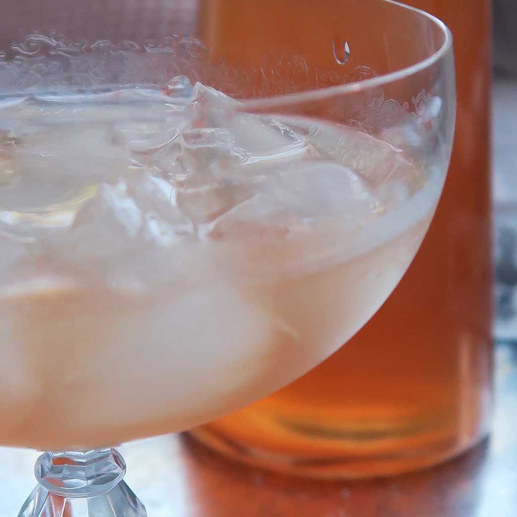 a glass of homemade ginger and rhubarb gin